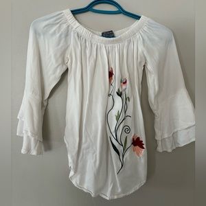 3/4 sleeve length shirt with embroidered flowers.
